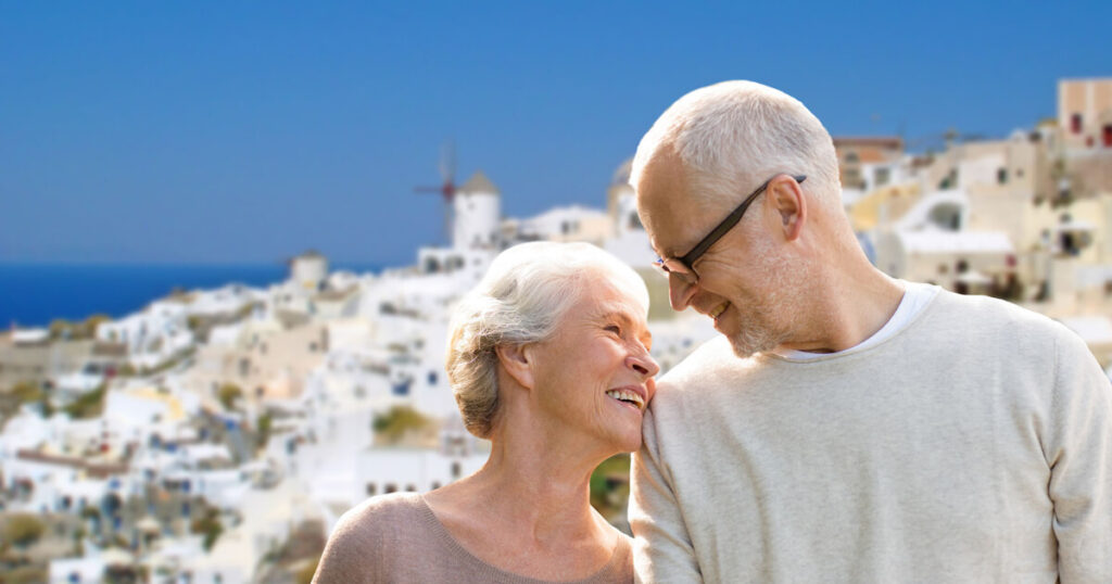 old age couple enjoying their trip in Greece, Santorini Island, Greece, white washed houses, Greek wind mill, travel tips over 60 years old.