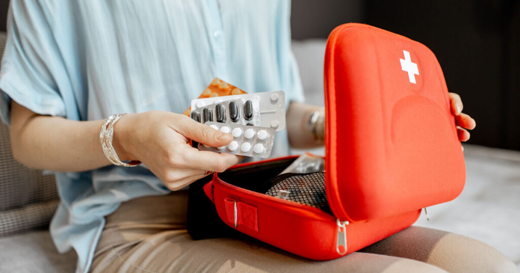 first aid kit, red colored kit for medicine.