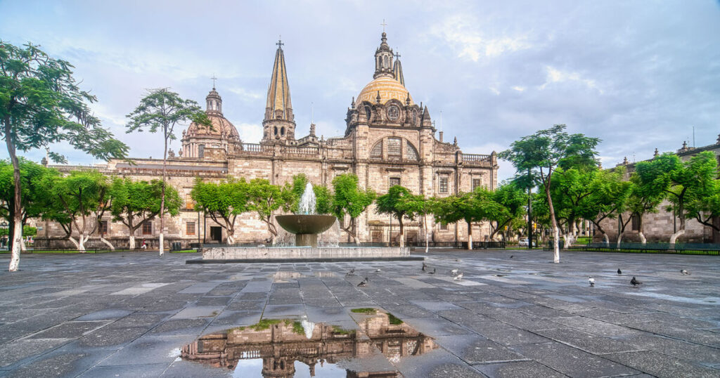Cathedral in Guadalajara, birds, trees, shadow in water, safest places to travel in Mexico.