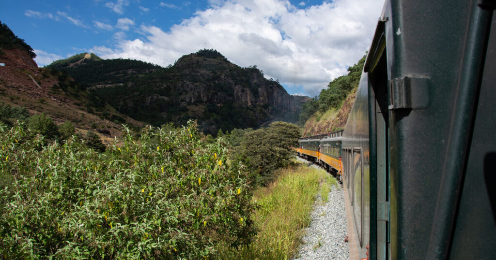 canyon in Mexico, train in Mexico, mountains with greenery.