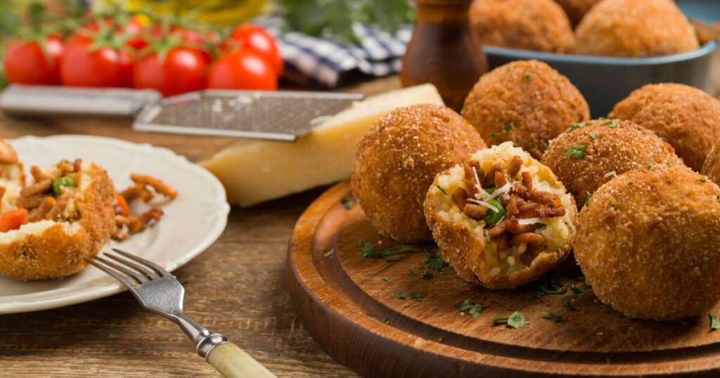 arancini, rice ball, meat ball, fork, cheese, the best street foods in Italy.
