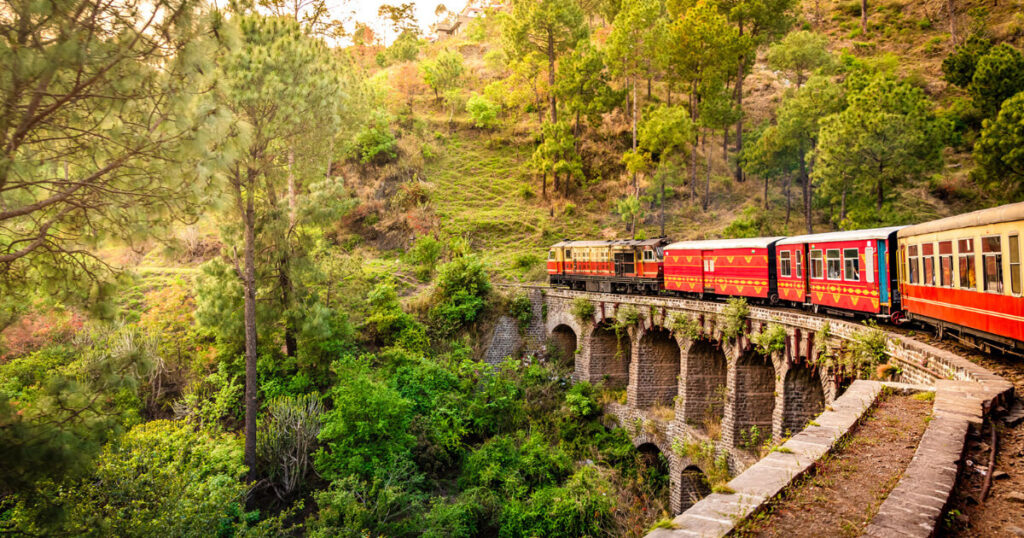 train in forest, Indian train, red colored train, train running on stone bridge.