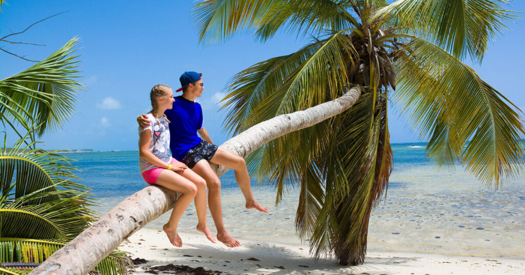 a couple on beach, coconut tree on beach, 10 budget-friendly honeymoon destinations in Asia.